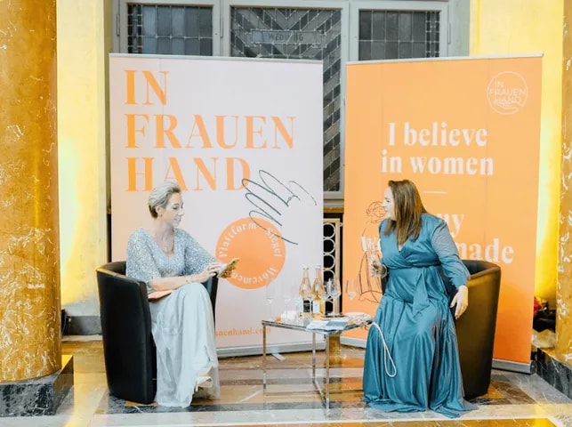 Two women in a fireside chat on stage
