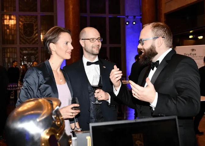 Guests in black tie deep in conversation