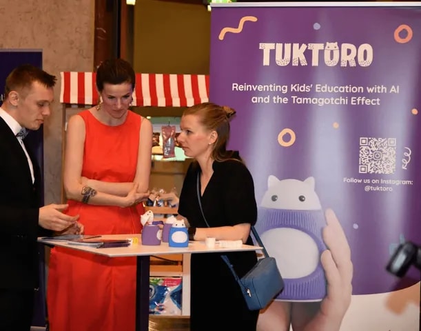 A startup presenting its product at a booth