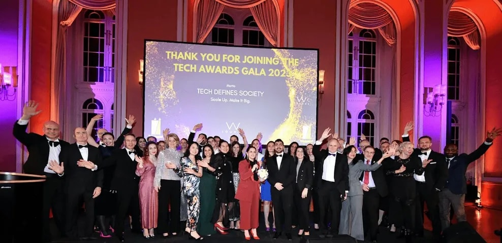 Everyone on stage under the "Thank you for joining" screen at the Gala